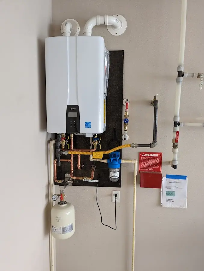 Professional plumber installing copper piping in a Bedford home